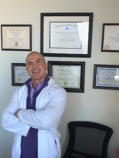 Current Google profile photo: Dr. Jones in a white coat standing in front of his framed credentials